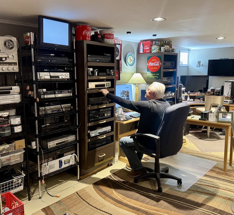 Roy working at his media conversion studio in Hamilton Township, NJ surrounded by VHS players and professional equipment